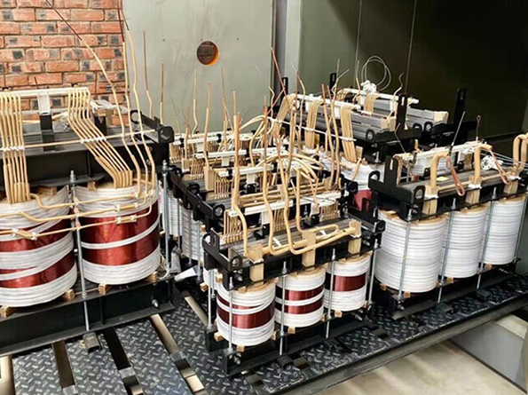 Transformer coil assemblies and lead connections